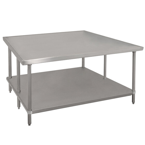 An Advance Tabco stainless steel work table with a galvanized undershelf.