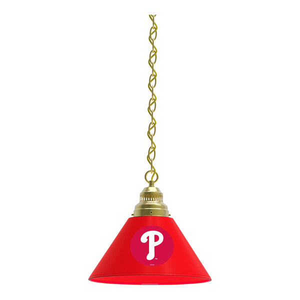 A red lamp shade with a white Philadelphia Phillies logo on it over a brass pendant light.