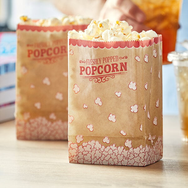 A couple of brown Carnival King popcorn bags with red text.