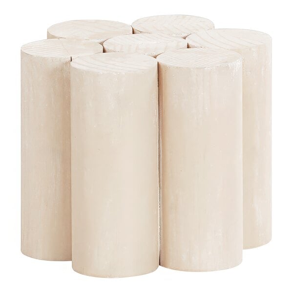 A group of four white Cal-Mil wooden cylindrical display risers stacked on top of each other.
