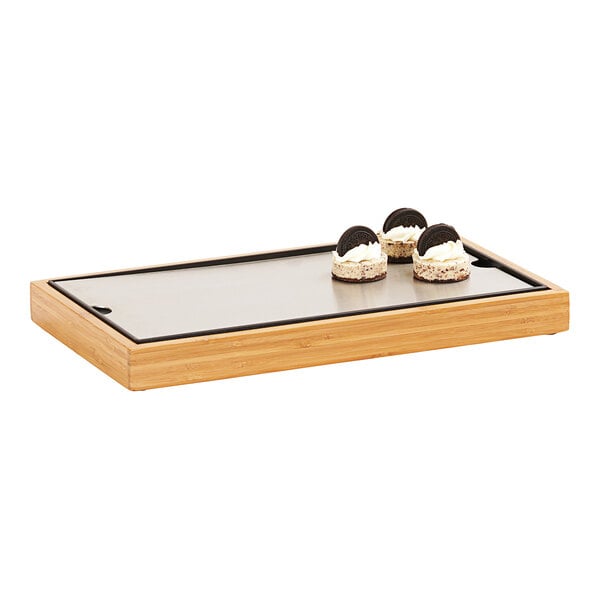 A wooden Cal-Mil tray holding a small dessert.