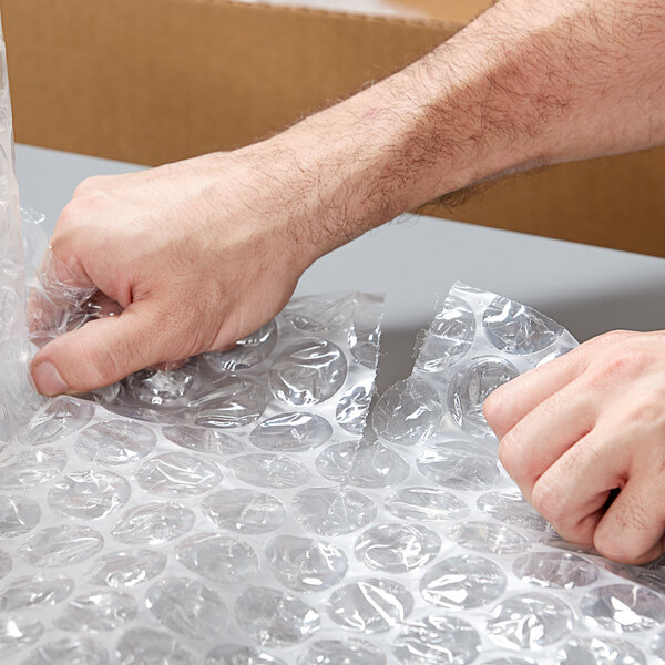 A person's hands holding a Lavex bubble wrap.
