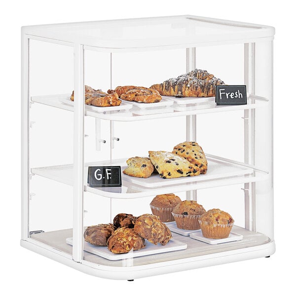 A Cal-Mil bakery display case filled with pastries and muffins.