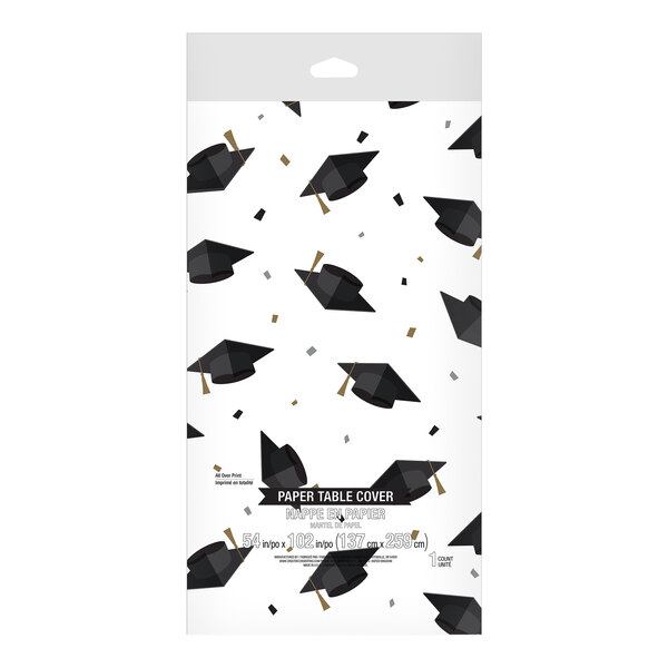 A white Creative Converting paper tablecloth with graduation caps printed on it.