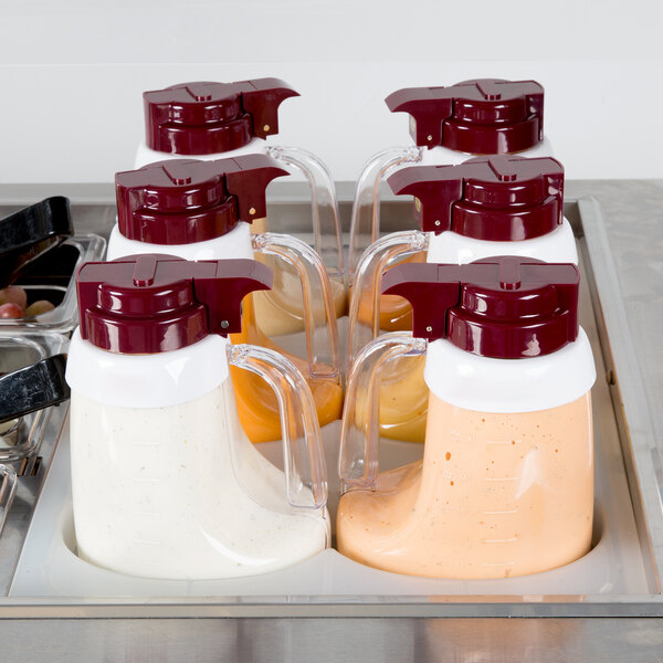 A white plastic Tablecraft salad dressing dispenser collar on a container of white liquid.