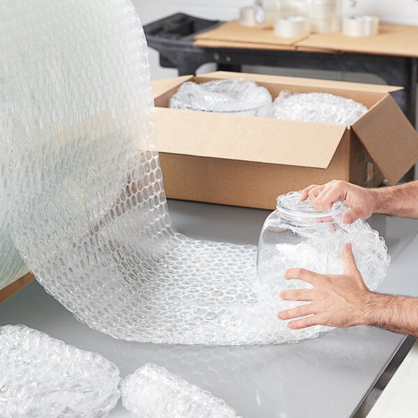 A person's hands reaching into a clear jar of Lavex bubble wrap.