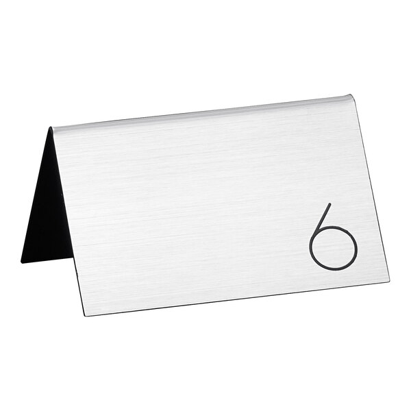 A silver rectangular Cal-Mil table tent with a black circle with the number 6 in it.