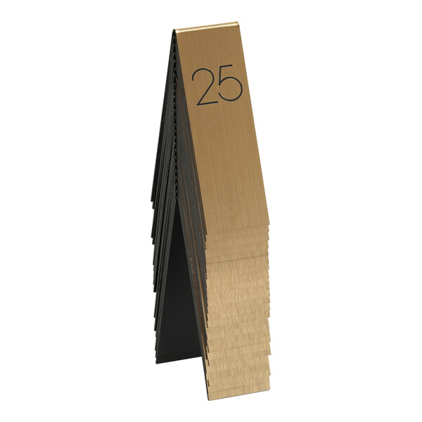 A stack of gold and black Cal-Mil table number tents.