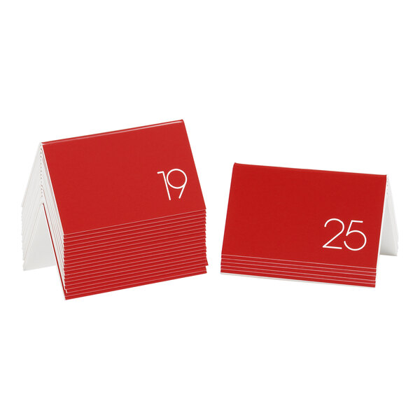 A stack of red Cal-Mil table tents with white numbers.
