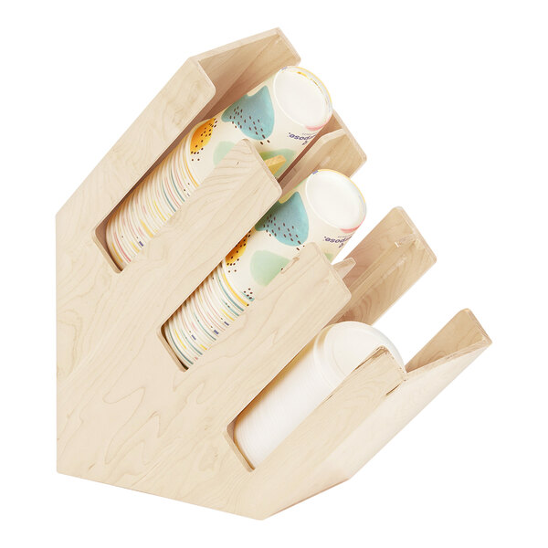 A Cal-Mil maple wood countertop cup and lid organizer with three sections holding cups.