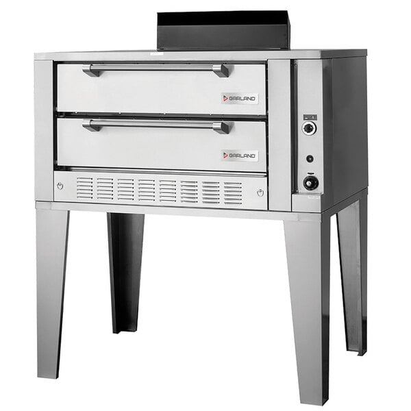 A silver stainless steel Garland double deck gas pizza oven with two drawers.