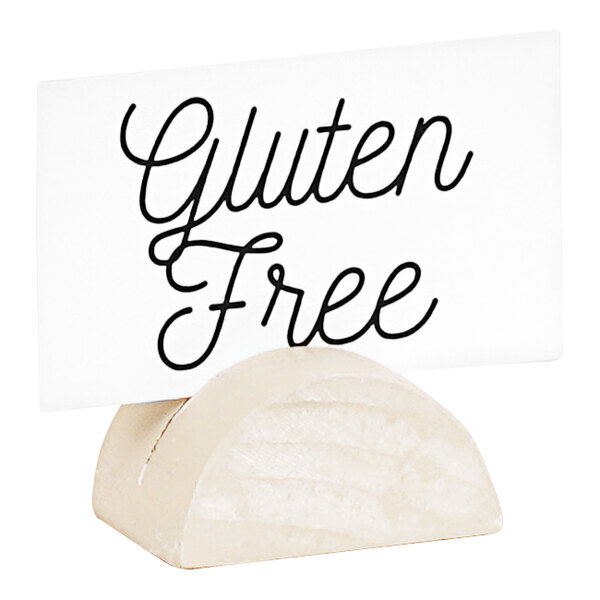 A white Cal-Mil arched pine wood table card holder with black text on a sign.