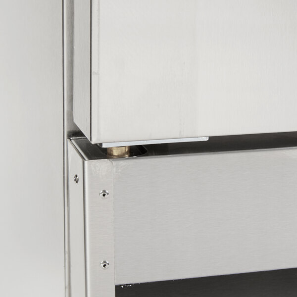 The bottom left hinge pivot for a Main Street Equipment stainless steel cabinet.