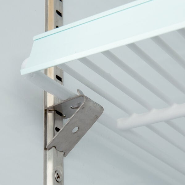 A metal shelf with a Main Street Equipment shelf clip attached to the corner.