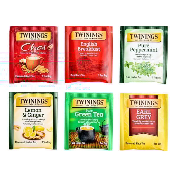 A variety of Twinings tea bags in red, yellow, and green packaging.