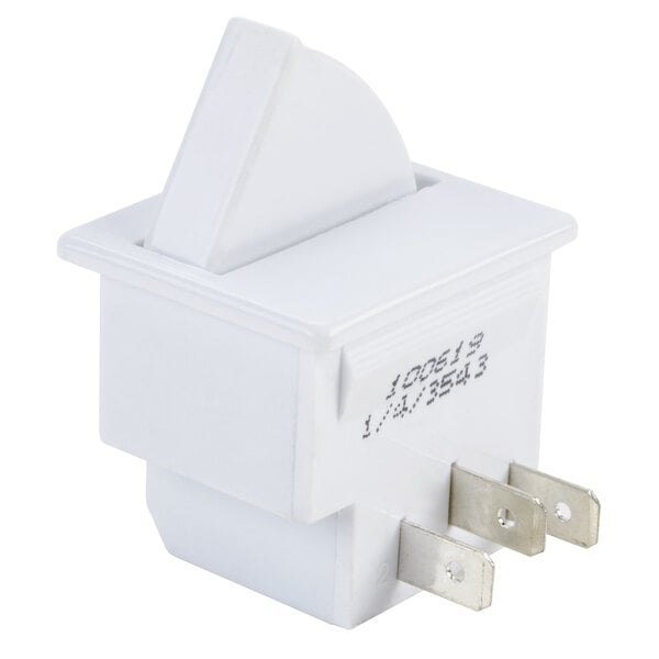 A white electrical device with metal terminals and a triangular shape.