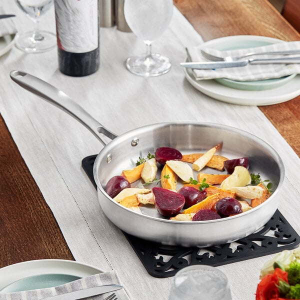A Vigor Tri-Ply stainless steel saute pan with vegetables in it.