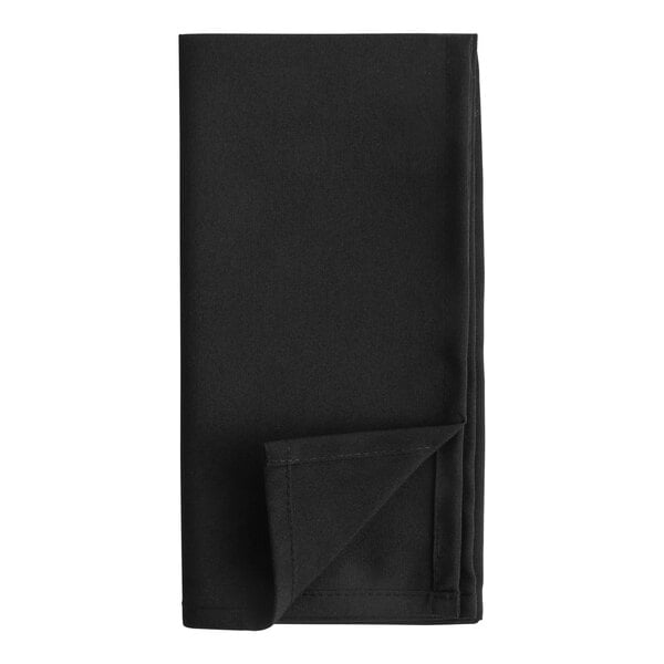 A black cloth napkin folded with a corner point up.