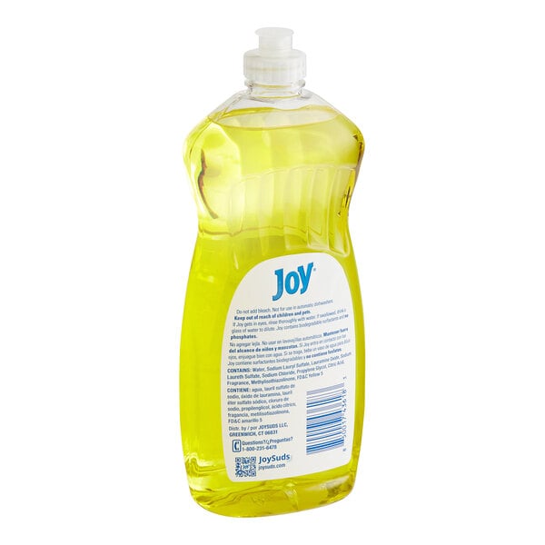 A yellow bottle of Joy lemon-scented dishwashing liquid on a counter.