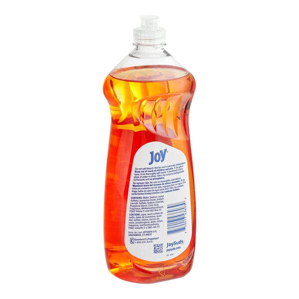 A bottle of Joy Orange Scented Dishwashing Liquid with an orange label.