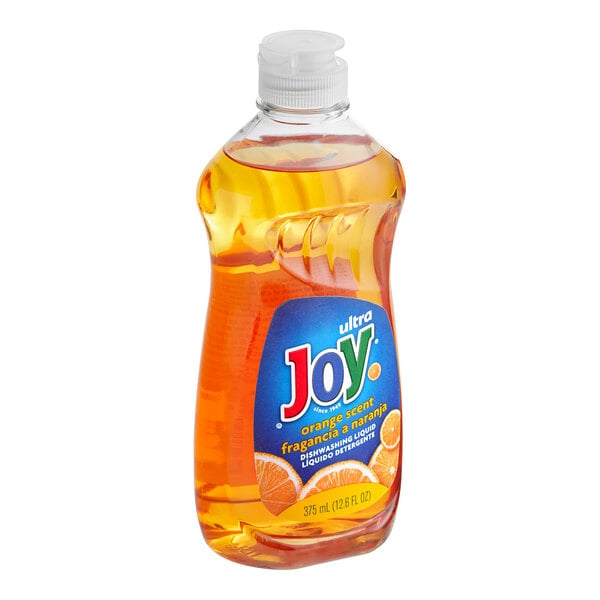 A bottle of Joy dishwashing liquid with orange liquid.