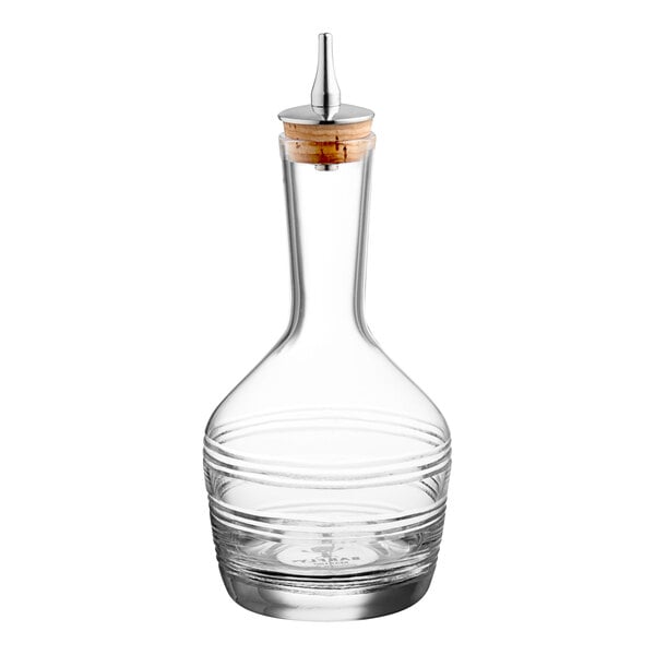 A clear glass Barfly bitters bottle with a cork stopper.