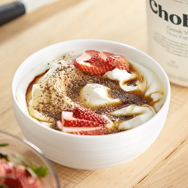 A bowl of Chobani Non-Fat Plain Greek Yogurt with strawberries.