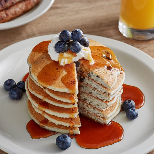 A stack of Krusteaz blueberry pancakes with syrup on top.