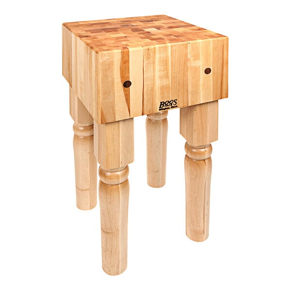 A John Boos maple butcher block table with legs.