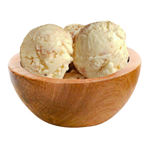 A wooden bowl with three scoops of G.S. Gelato Biscotti gelato.