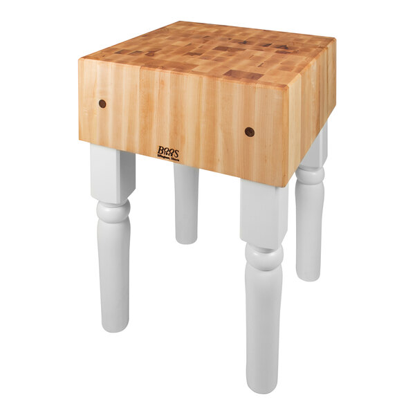 A John Boos maple butcher block with white legs.