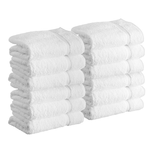 A stack of white Lavex Premium bath towels.