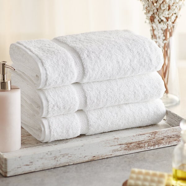 A stack of Lavex Premium white bath towels.