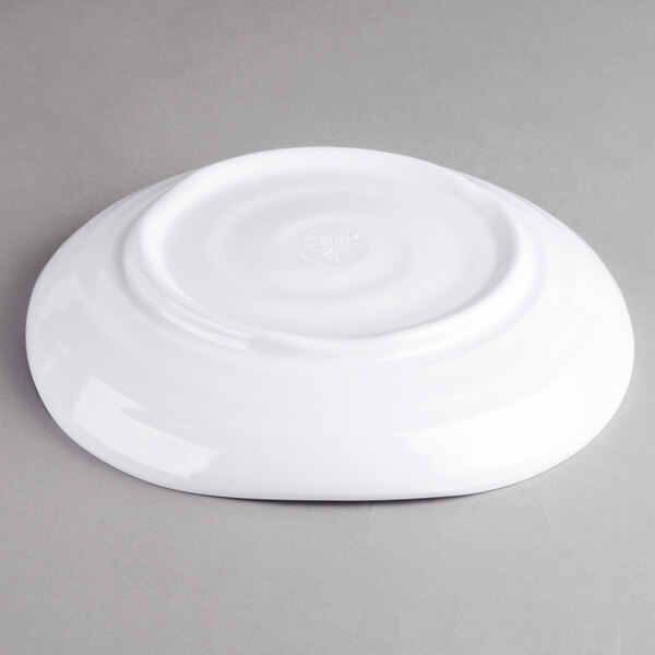 A white Carlisle square melamine plate on a gray surface.
