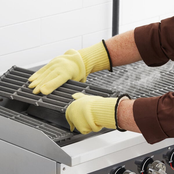 A person wearing yellow Ansell ActivArmr kitchen gloves.