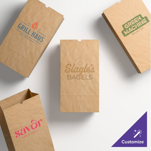 A set of natural kraft paper bags with various custom printed logos and designs.