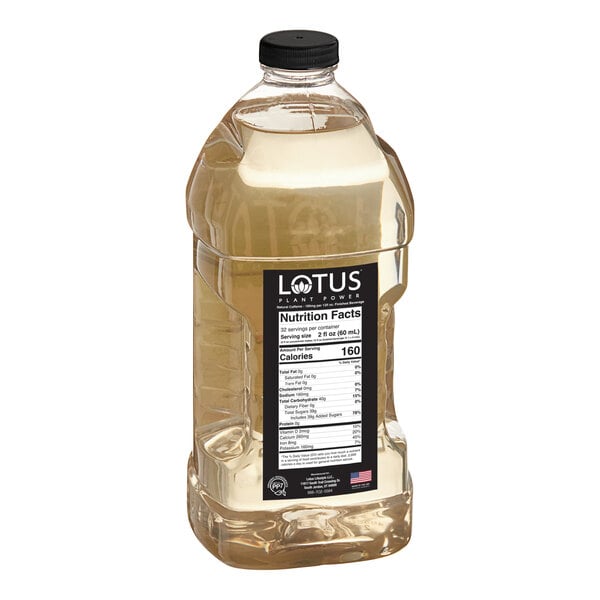 A large clear plastic bottle with a black cap containing a light yellow liquid and a label displaying nutrition facts and branding.
