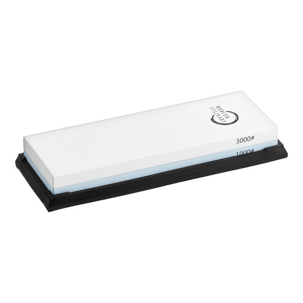 A rectangular dual-grit sharpening stone with 1000 and 3000 grit sides, mounted on a black base.