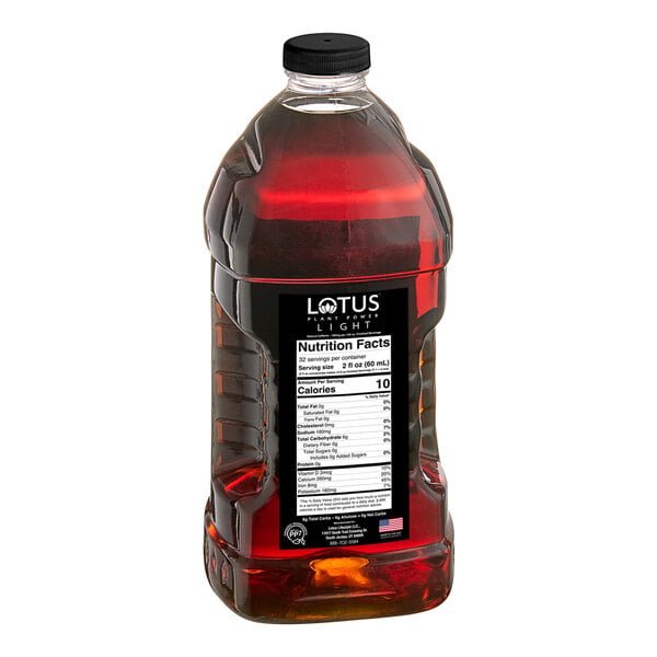 A large clear plastic bottle filled with a dark amber liquid, featuring a black label with nutrition facts and a black screw cap.