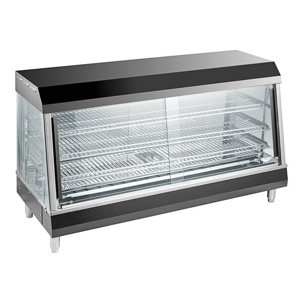 A black and silver Vollrath countertop hot food merchandiser with a glass door on a counter.