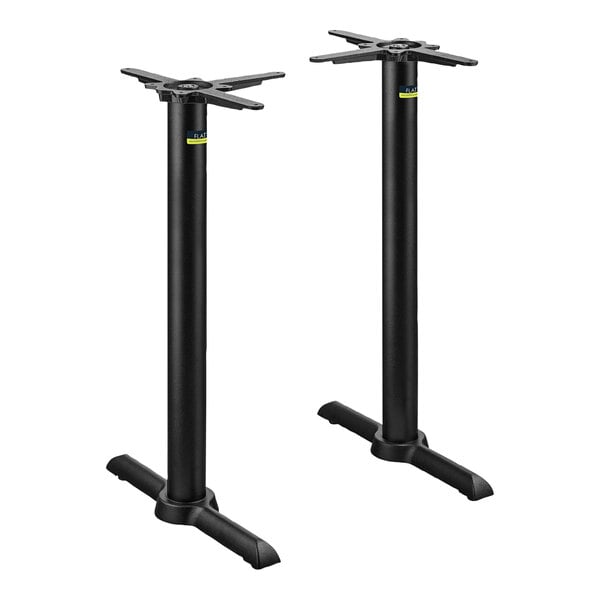 A pair of FLAT Tech black metal table bases stacked on top of each other.