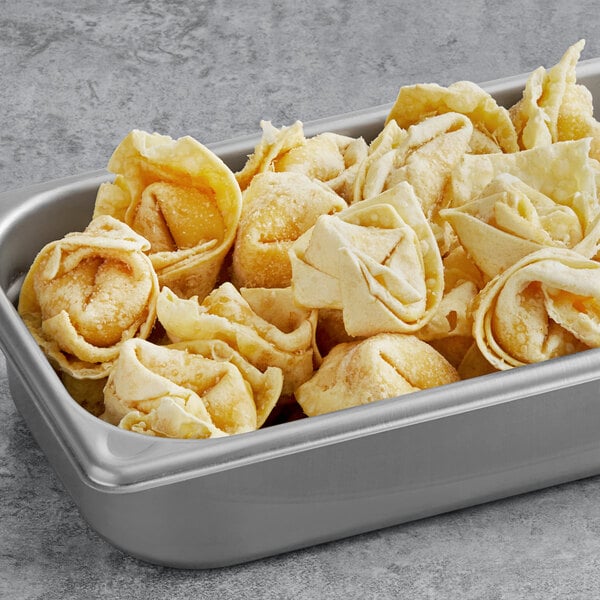 A silver tray of Amoy Royal Dragon Crab Rangoon on a school kitchen counter.