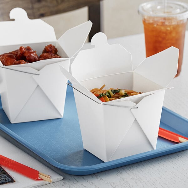 Two Emperor's Select white paper take-out boxes filled with food.