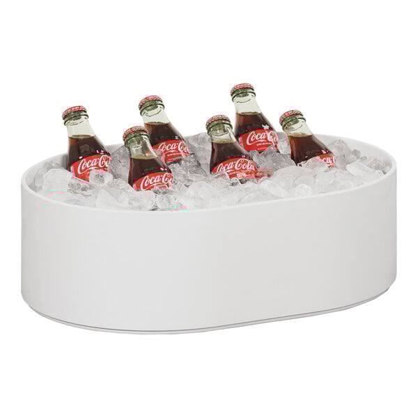 A Cal-Mil white melamine bowl filled with ice and soda bottles.
