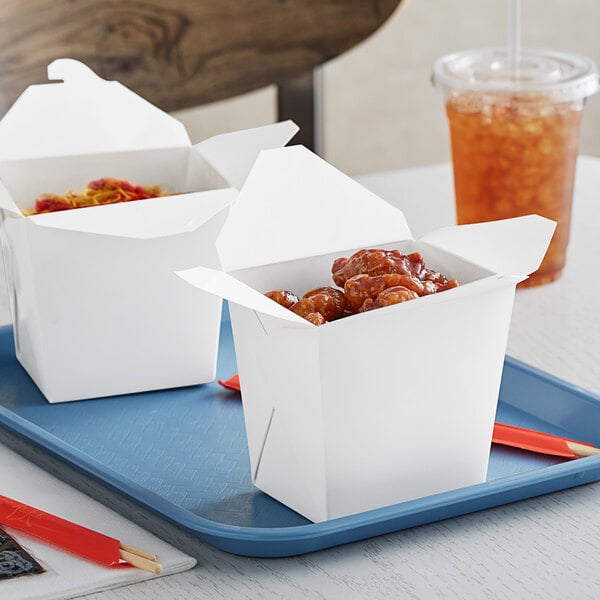 A tray with two Emperor's Select white microwavable take-out containers filled with food.