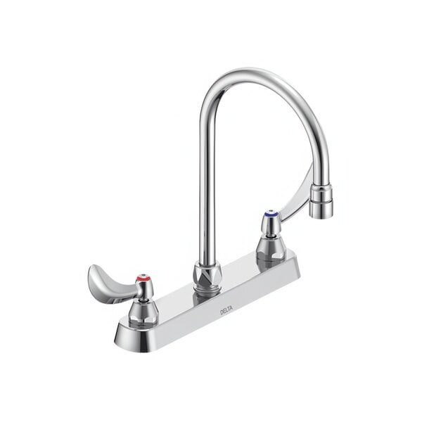 A close-up of a silver Delta deck-mount faucet with curved spouts and dual blade handles with sanitary hoods.