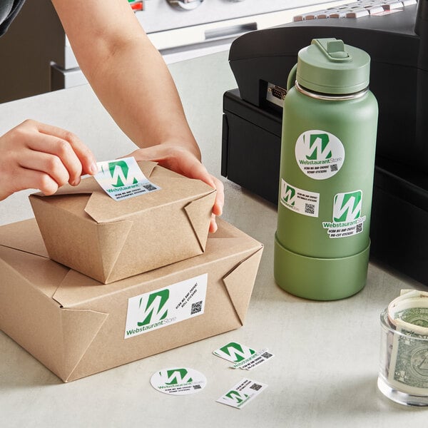 A person packing boxes with Carnival King vinyl stickers.