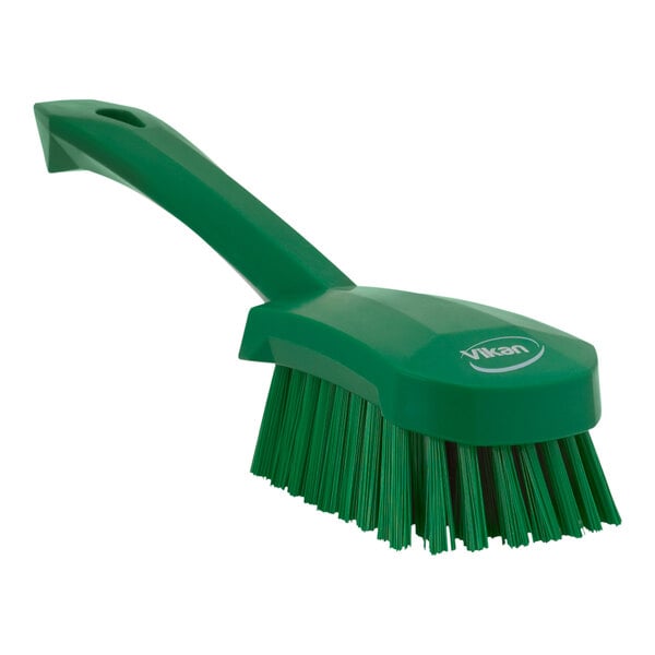 A green Vikan washing brush with a handle.