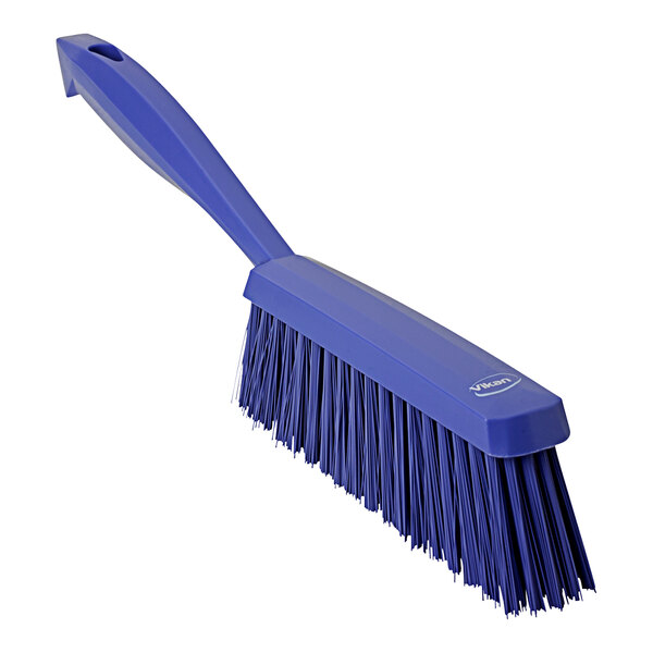 A purple Vikan hand brush with a handle.