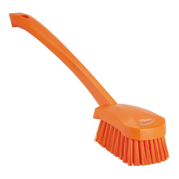 A Vikan orange washing brush with a handle.